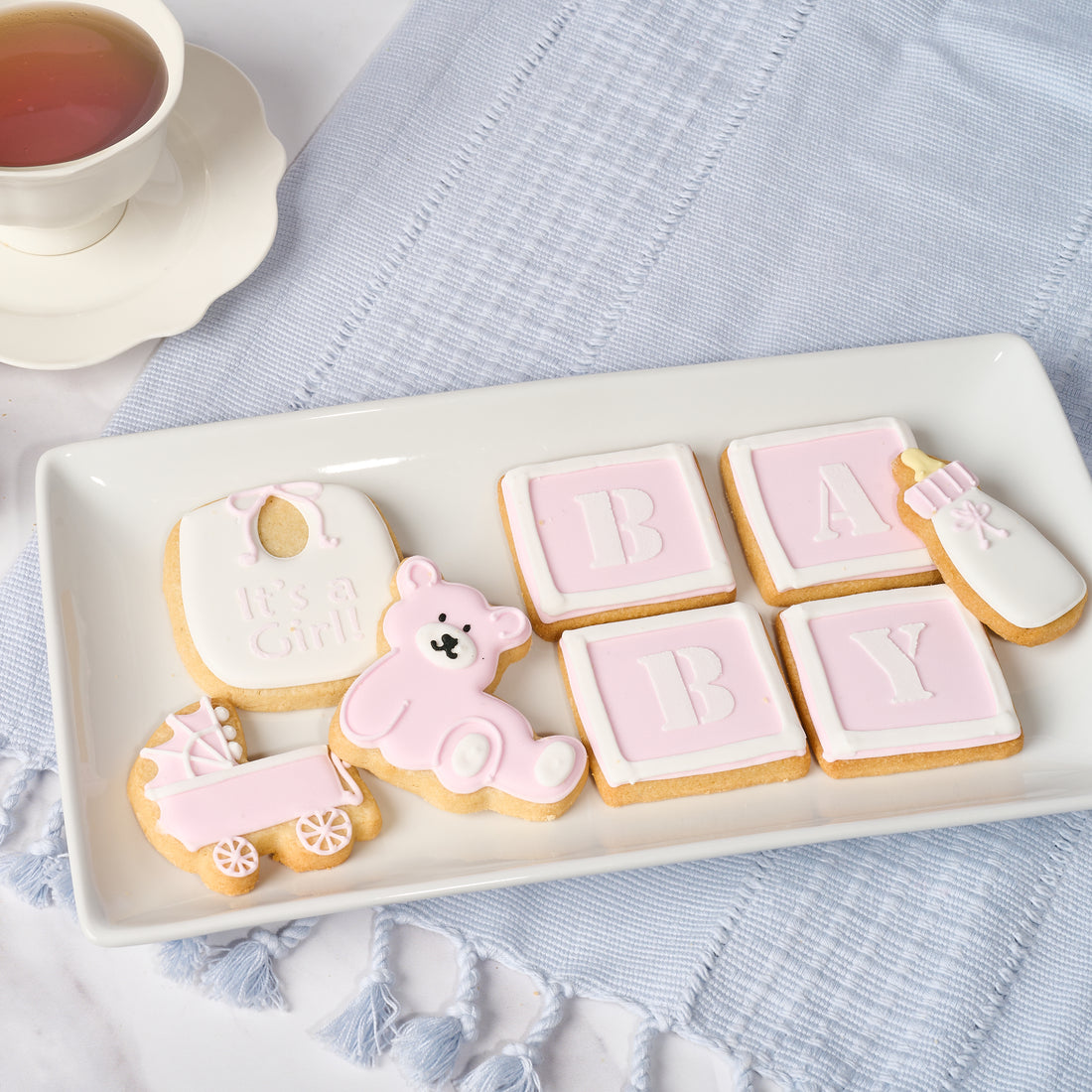 A platter of decorated cookies spelling out &